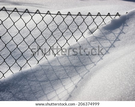 fence in winter with snow
