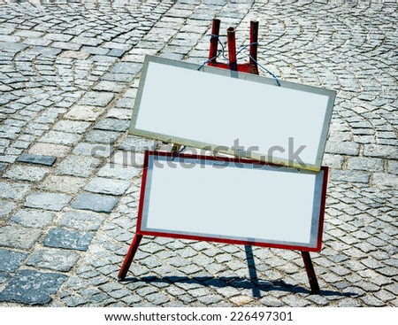 blank signs and cobblestone - nice background with space for text
