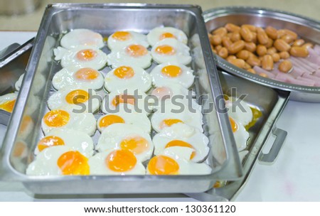 Fried egg and hot dog and ham / Breakfast is Preparation served  in tray