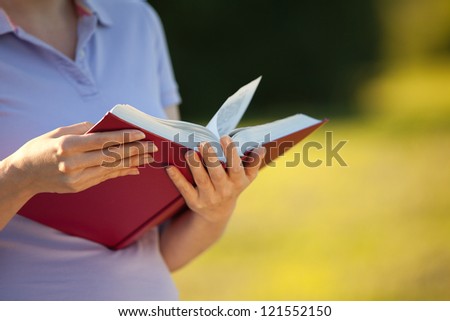 woman reading a book (summer day, foreground focus)