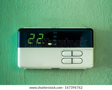 twenty two  celsius heating and cooling air conditioning display on green wall