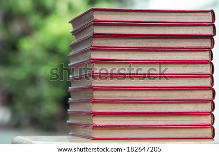 stack of old red cover book on wooden  table