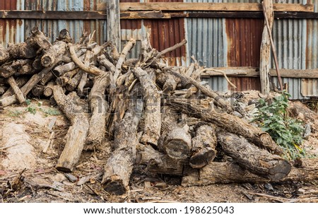 pile of old wooden pole and galvanized iron fence