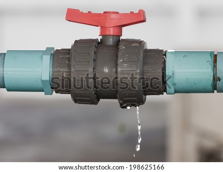 leaking water from blue pipe and red valve