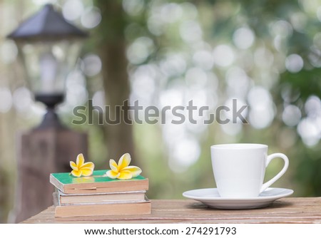 coffee cup book and yellow flower on wooden table
