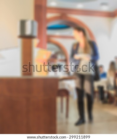 blur woman and food table in dining room