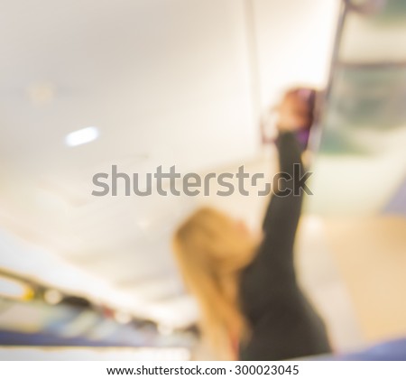 blur passenger take out bag from shelf in train