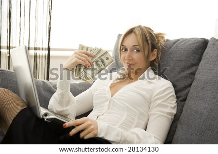 happy woman earning money on her laptop at home