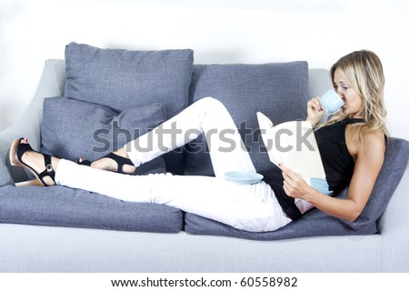 woman at home having tea and reading