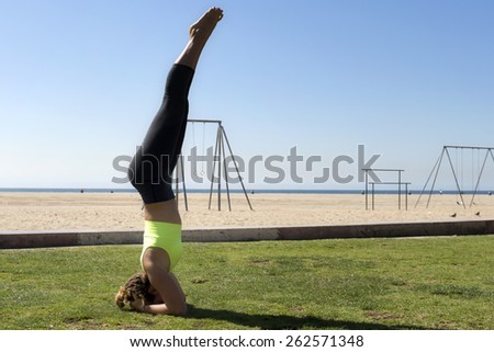 Woman performing a balancing headstand