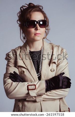 Portrait of young beauty dark hair girl in 1960 style in vintage style black glasses