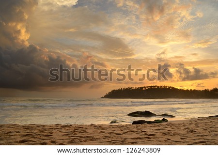 Like an atomic explosion, clouds gathering at the horizon at the tropical beach of Mirissa, Sri Lanka. Double exposure shot taken at dusk during monsoon season.