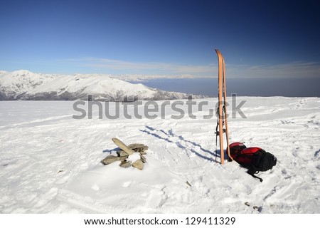 On the top of the mountain, pair of back country - tour ski and a backpack with avalanche safety tools  Scenic high mountain background  M  Rosa range, 4634 m