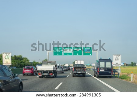 Turin, Italy - June 5, 2015: Traffic and queue in the morning rush hour on the highway A4 Milan to Turin, the most important business and industrial poles in Northern Italy.