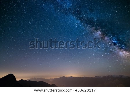 The outstanding beauty of the Milky Way and the starry sky captured at high altitude in summertime on the Alps in Valle d\'Aosta. Wide angle view, some acceptable digital noise and grain.