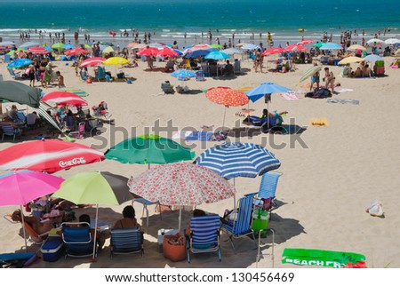 THE PORT OF SAINT MARY, SPAIN - JULY 22: Busy beach on July 22, 2012 in The Port of Saint Mary, Spain. Crowed beach in a Sunday day of summer. The beach is located in the province of Cadiz, Andalusia.