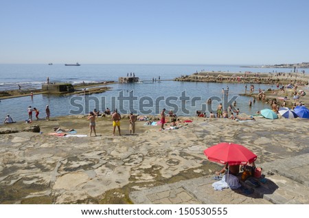 ESTORIL, PORTUGAL - AUGUST 12: Busy beach in a day of summer on August 12, 2013 in Estoril, Portugal.  Estoril is a civil parish of the Portuguese municipality of Cascais, in central Lisbon district.