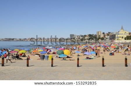 ESTORIL, PORTUGAL - AUGUST 12: Busy beach in a day of summer on August 12, 2013 in Estoril, Portugal.  Estoril is a civil parish of the Portuguese municipality of Cascais, in central Lisbon district.
