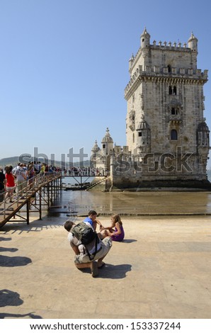 LISBON, PORTUGAL - AUGUST 14: Long queue to go into the Belem Tower on August 14, 2013 in Lisbon, Portugal. The tower was part of a defense system at the mouth of the Tagus river.