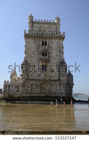 LISBON, PORTUGAL - AUGUST 14: People in front of the Belem Tower on August 14, 2013 in Lisbon, Portugal. The tower was part of a defense system at the mouth of the Tagus river.