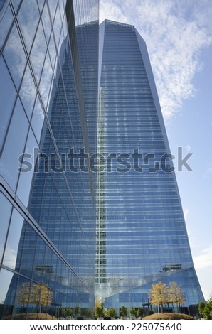 MADRID, SPAIN - OCTOBER, 18: Reflection of the Crystal Tower into the Tower Space on October 18, 2014 in Madrid, Spain. The Crystal tower was designed by Pelli and the Space tower by  Henry N. Cobb.