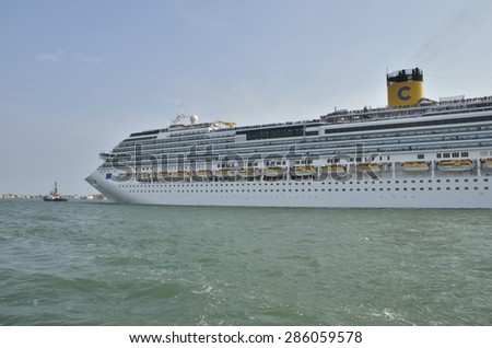 VENICE, ITALY - AUGUST 11: Lots of people in a cruise ship sailing by the Grand Canal on August 11, 2014 in Venice, Italy.