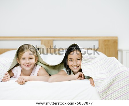 Portrait of Young Girls under Bed Sheets