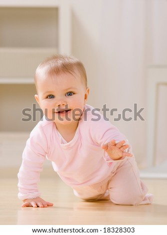 Close up of smiling baby crawling on livingroom floor [Approx. 8 mos]