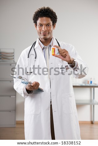 Confident doctor wearing lab coat holding prescription bottle and medical chart
