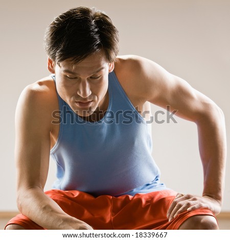 Fatigued man in sportswear relaxing after work out