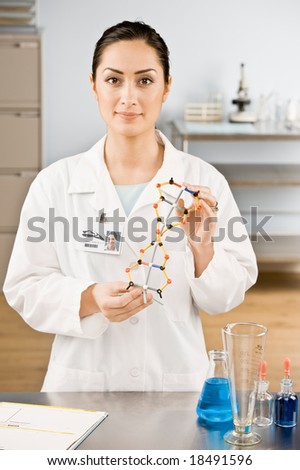 Research scientist holding molecular model in laboratory