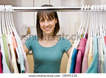Curious teenager searching in closet for something to wear