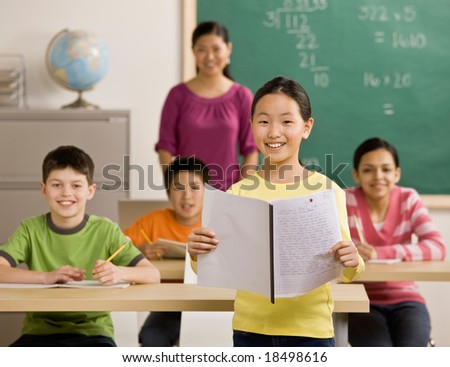 Confident student reads her report in school classroom