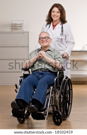 Doctor pushing disabled patient in wheel chair in doctor?s office