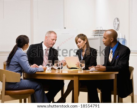 Co-workers having financial meeting in conference room