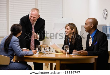 Co-workers having financial meeting in conference room