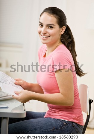 Responsible woman opening envelope to pay monthly bills