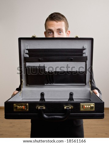 Worried businessman opening empty briefcase