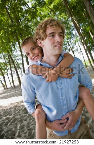 Father giving son piggy back ride