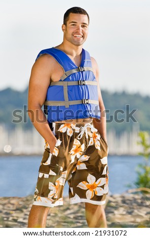 Man wearing life jacket at beach