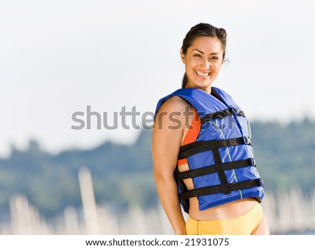 Woman wearing life jacket at beach