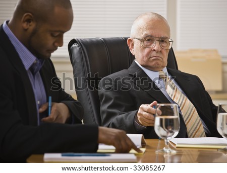 Two business men meeting,one African American, one white senior male. Horizontal.