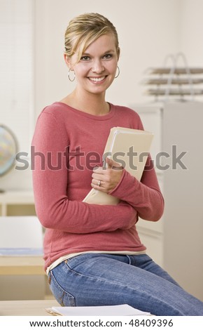 Student holding file folder