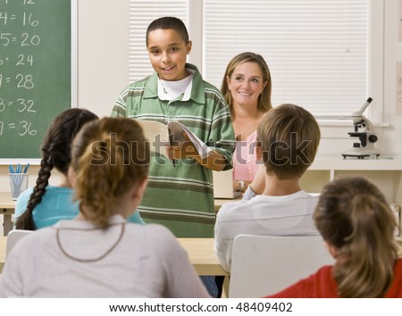 Student giving report in classroom