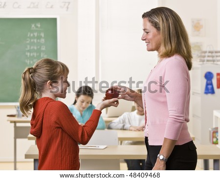 Student giving teacher apple