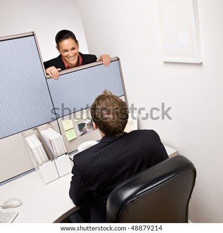 Businesswoman talking to co-worker in next cubicle