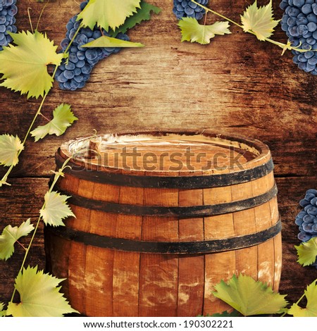 Grapes and old barrel on a wooden background. Wine concept.