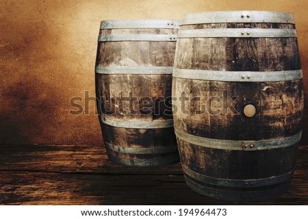 Old oak barrels on the wall background.