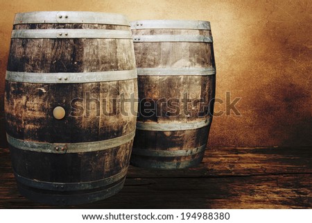 Old oak barrels on the wall background.
