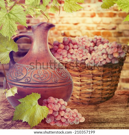 Ceramic jug and grapes on the table. Wine concept.